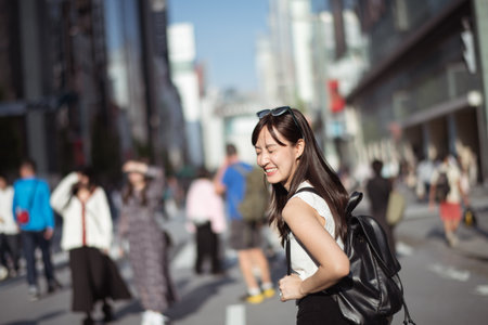 Youthful confidence, Cool and cheerful woman in her 20s, showcasing perfect blend of style, confidence, and modern technology.の写真素材