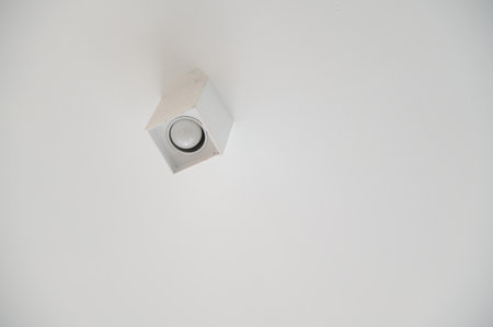 A close up of minimalist ceiling light fixture showcasing simple yet modern design mounted on clean...