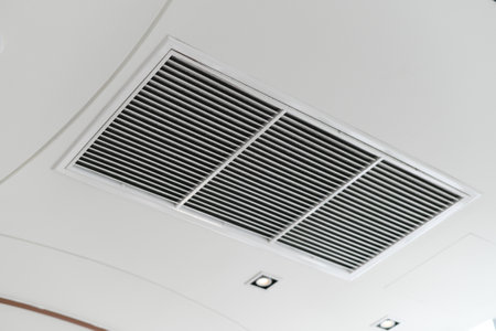 A clean modern interior showing ceiling air vent grille. hvac air conditioner ventilation duct system provides comfortable cooling for healthy indoor air quality and climate controlの写真素材