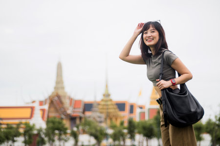 A joyful solo southeast asian woman teenager blogger and world travel explorer. enjoying local cultural tourism experience in bangkok, heart of asia, thailand. great travel conceptの写真素材