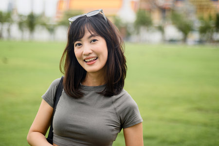 A happy solo southeast asian woman and teenager blogger on world travel. local cultural experience in bangkok thailand creating an asia tourism concept for fun explorerの写真素材