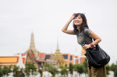A happy solo southeast asian woman teenage blogger and world travel explorer enjoys local cultural tourism experience in bangkok thailand. concept for travel in asiaの写真素材