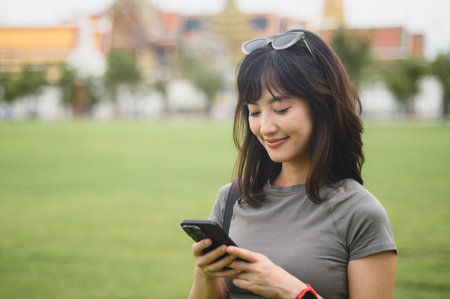 A happy solo southeast asian woman teenager blogger explorer on world travel. tourism concept to...