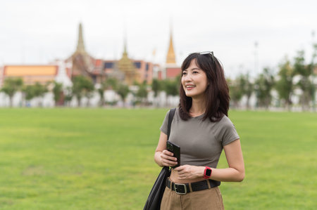 A happy solo southeast asian woman young teenager blogger and world travel explorer enjoying local cultural tourism experience in bangkok thailand. great asia travel conceptの写真素材