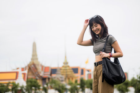 Happy solo Southeast Asian woman and teenager blogger on world travel tourism explorer journey in Bangkok Thailand for local cultural experience in Asia, travel conceptの写真素材