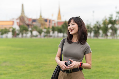 Happy solo Southeast Asian woman and teenager blogger enjoys world travel. tourism concept for local cultural explorer experience in Bangkok Thailand Asiaの写真素材