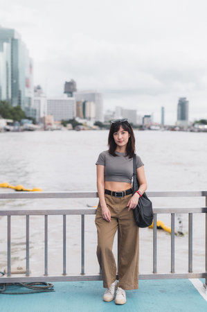 Solo Southeast Asian woman teenager blogger and world travel explorer. To wait and express calm over boat tourism concept. local cultural experience on Chao Phraya River Bangkok Thailand Asiaの写真素材