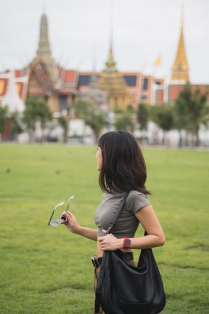 Solo southeast asian woman teenager blogger on world travel. pensive explorer enjoying local cultural tourism concept and experience in Bangkok Thailand asiaの写真素材