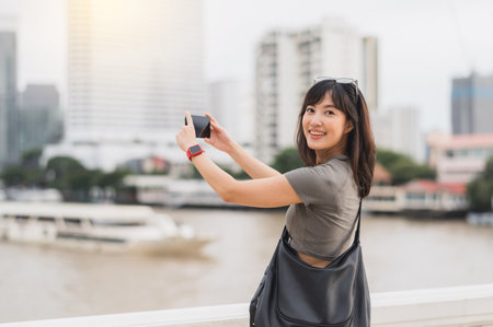 Happy solo Southeast Asian woman teenager blogger on world travel. tourism concept to take photo of...