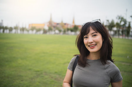 Happy solo southeast asian woman teenager blogger on world travel tourism adventure in Bangkok Thailand. local cultural experience for an explorer in asia conceptの写真素材