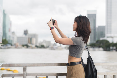 Solo southeast asian woman teenager blogger world travel explorer wait to take photo. Express asia tourism concept and local cultural experience of boat on Chao Phraya river Bangkok Thailandの写真素材