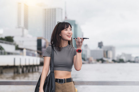 Happy solo southeast asian woman teenager blogger express to friend smartphone local cultural experience. World travel explorer wait for boat Chao Phraya River asia tourism concept Bangkokの写真素材
