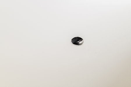 Close up detail of single black screw shows precision needed for house renovation and construction projects focused view of essential hardware for meticulous workの写真素材