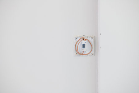 Close up detail of new electrical wiring inside wall box during house renovation. bare construction...