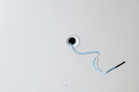 Close up detail of electrical wiring during house construction. renovation project featuring hole in...