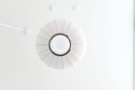 White ceiling lamp modern lighting minimalistic style circular shape interior decor soft...