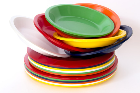 Stacked colorful plastic plates isolated on white backgroundの写真素材