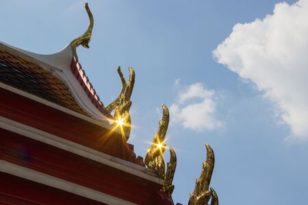 The roof with ornemental roof points shaped like the head of the Garuda and toothlike ridges on the sloping edges of a gable, representing the fin on the back of Naga of Pho Temple, Bangkok, Thailandの写真素材