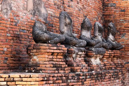 A row of Buddha statues without head in Wat Chaiwatthanaram Temple of Ayuthaya Province ( Ayutthaya Historical Park ) Thailandの写真素材