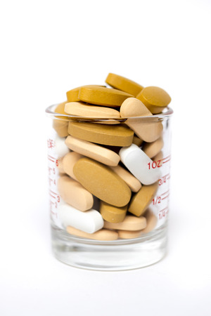 Medical shot - glass full of pillsの写真素材
