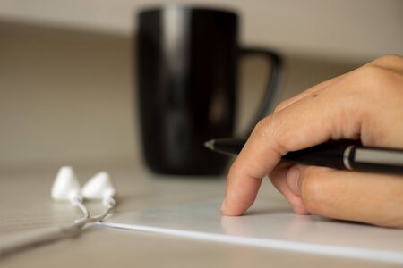 Writing and thinking message in note with coffeeの写真素材