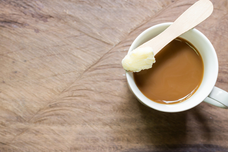 Coffee blended with butter tester good. New trend may forever change the way you drink coffee. Instead of the usual cream and sugar, on wooden background  with copy spaceの写真素材