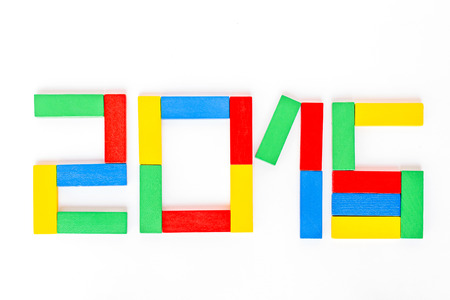 Happy New Year 2016 arranged from blocks wooden game jenga isolated on white background; Year of fun colorful concept.の写真素材