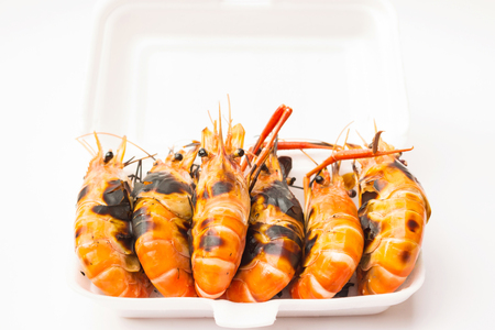 Charcoal grilled river prawns served in styrofoam box; street food stall in Thailandの写真素材