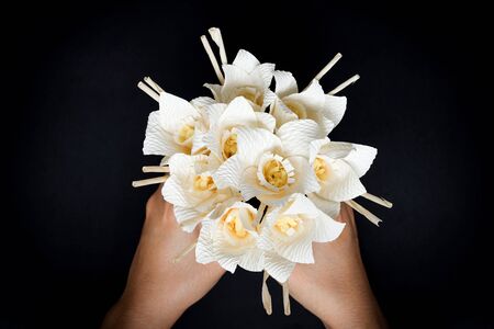 Kind of wood flower in hand; to be placed on the site of cremation in Thailand. (Dok Mai Jan)の写真素材