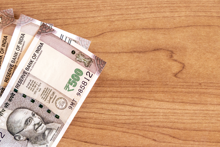 New series Indian five hundred rupee notes on wooden table background with copy space.