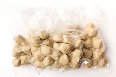 Pork balls in vacuum package isolated on white backgroundの写真素材