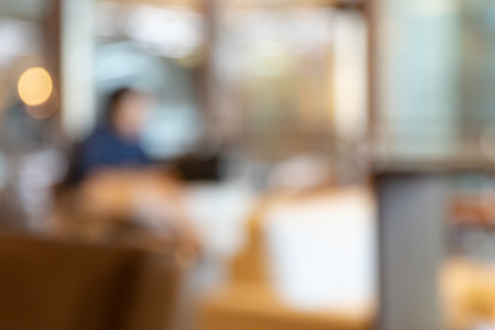 Blurred image of tables and chairs at restaurant backgroundの写真素材