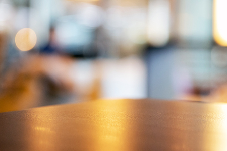 Texture of wood surface with warm shade lighting and copy space with interior blurred for background; soft focus.の写真素材