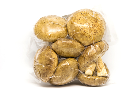 Fresh Shiitake mushroom in vacuum package isolated on white background.の写真素材