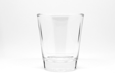 Empty small shot glass isolated on white background.の写真素材