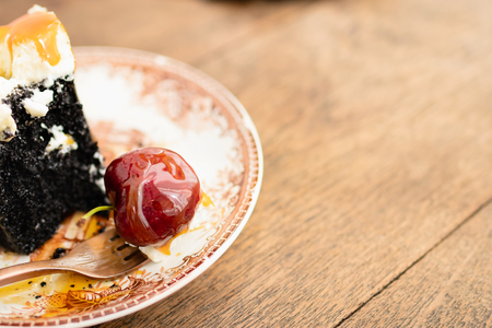 Dark beer chocolate cake (Chocolate Stout Cake) with caramel sauce and juicy fruits on top. Copy spaceの写真素材