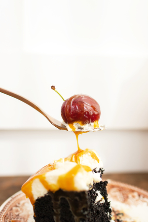 Dark beer chocolate cake (Chocolate Stout Cake) with caramel sauce and juicy fruits on top.の写真素材