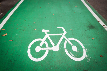 Empty green cycle track with bike lane signの写真素材