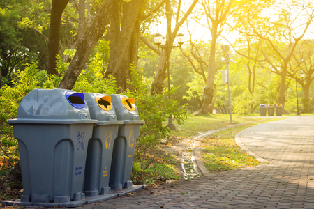 Segregated waste bins for garbage in public park.の写真素材