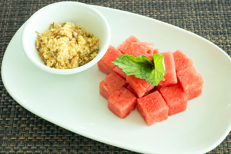 Watermelon with sweet dried fish crispy shallot dip, traditional Thai snack which is a good refreshment for the hot summer.の写真素材