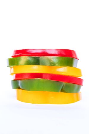 Stack of bell pepper slices isolated on white background.の写真素材