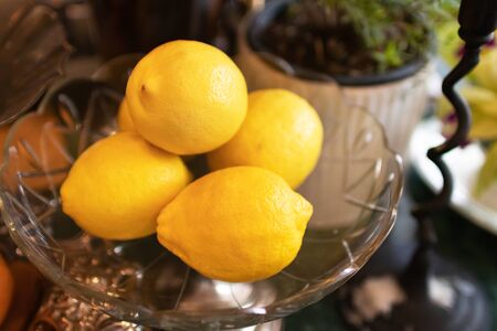 Group of fresh lemon on vintage glass serving tray.の写真素材