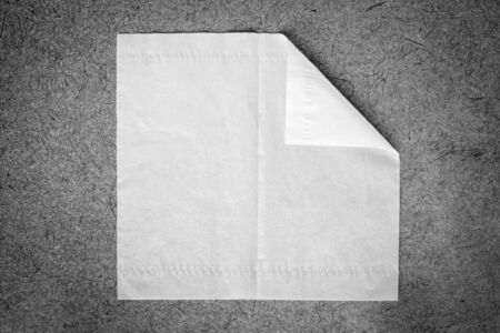Blank paper napkin with copy space isolated on mulberry paper background, black and white tone.