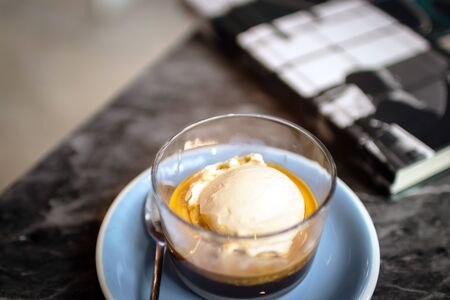 Affogato coffee, espresso shot with salted caramel ice cream on classic marble table background.の写真素材