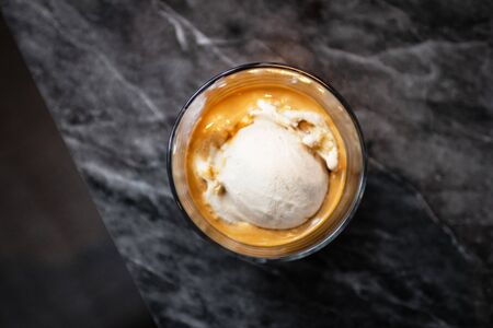 Affogato coffee, espresso shot with salted caramel ice cream on classic marble table background, top view.の写真素材