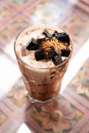 Iced chocolate with black jelly on table at cozy place. Favorite drink in afternoon.の写真素材