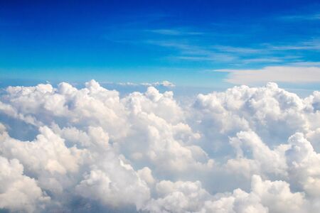 Blue sky with fluffy clouds; soft cirrus white clouds in the sky. Skyscraper background.