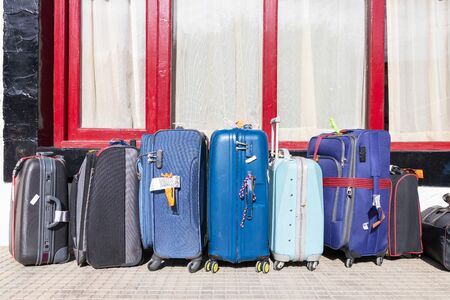 Suitcases multicolor waiting for hotel check-in. Travel Concept.