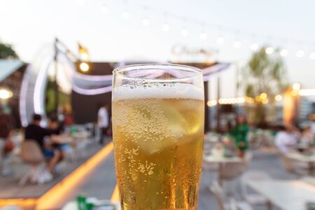 Glass of beer with abstract blurred background of bar and restaurant.の写真素材