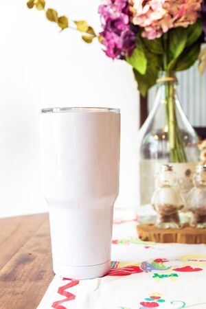 White tumbler glass cold store. Stainless steel  tumbler mug on table. No plastic with reuse item; save world.の写真素材